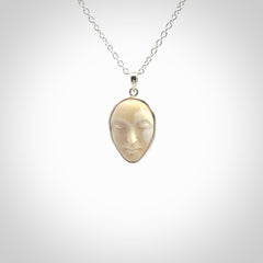 Hand made woolly mammoth tusk moon face necklace. Made by NZ Pacific and sale online only.