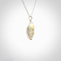 Hand made woolly mammoth tusk moon face necklace. Made by NZ Pacific and sale online only.