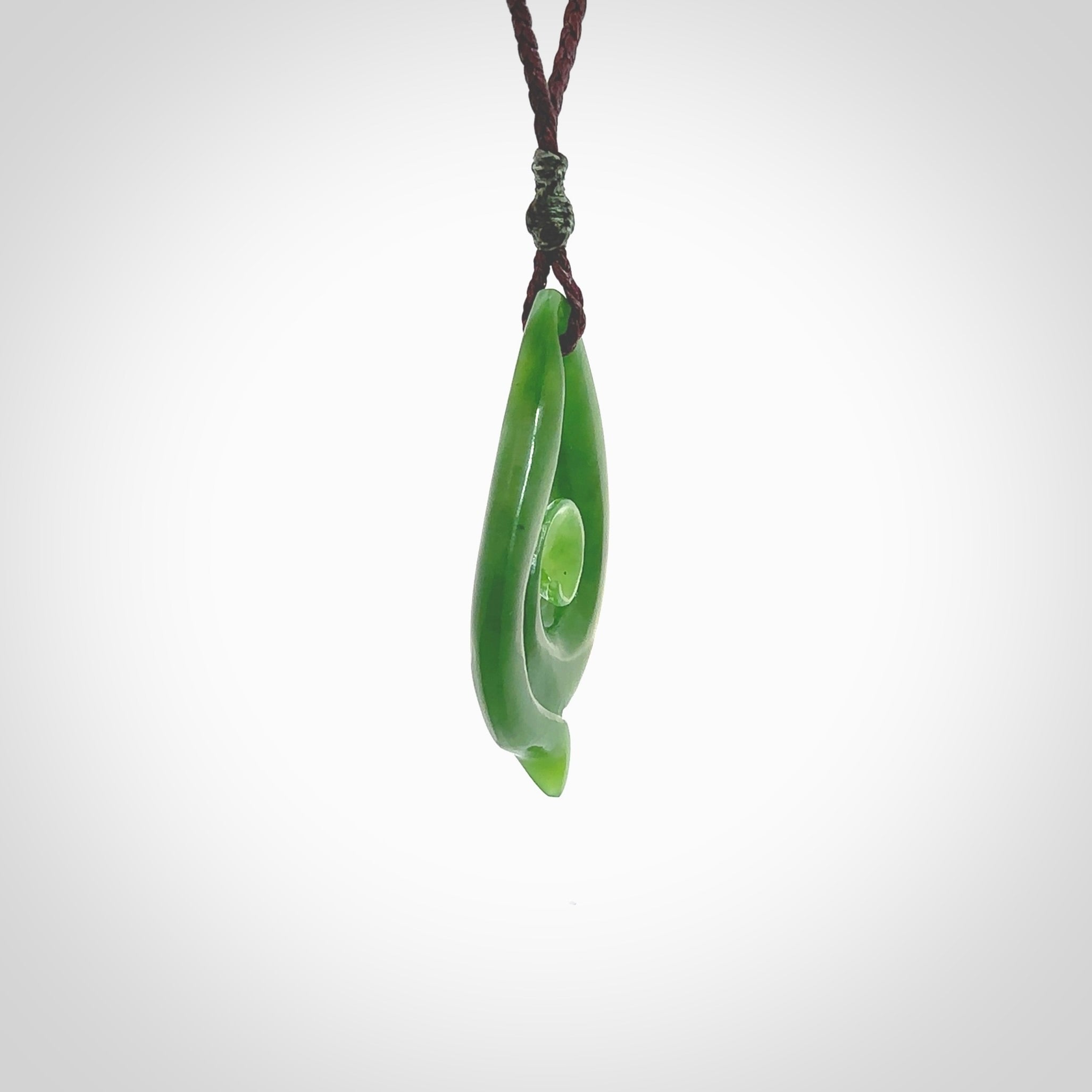 This pendant is a contemporary, medium sized and beautiful koru necklace carved from New Zealand Kawakawa Jade. Ross Crump carved this piece for us so the workmanship is outstanding. Handmade in New Zealand, a beautiful piece of jade jewellery.