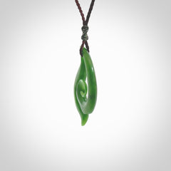 This pendant is a contemporary, medium sized and beautiful koru necklace carved from New Zealand Kawakawa Jade. Ross Crump carved this piece for us so the workmanship is outstanding. Handmade in New Zealand, a beautiful piece of jade jewellery.