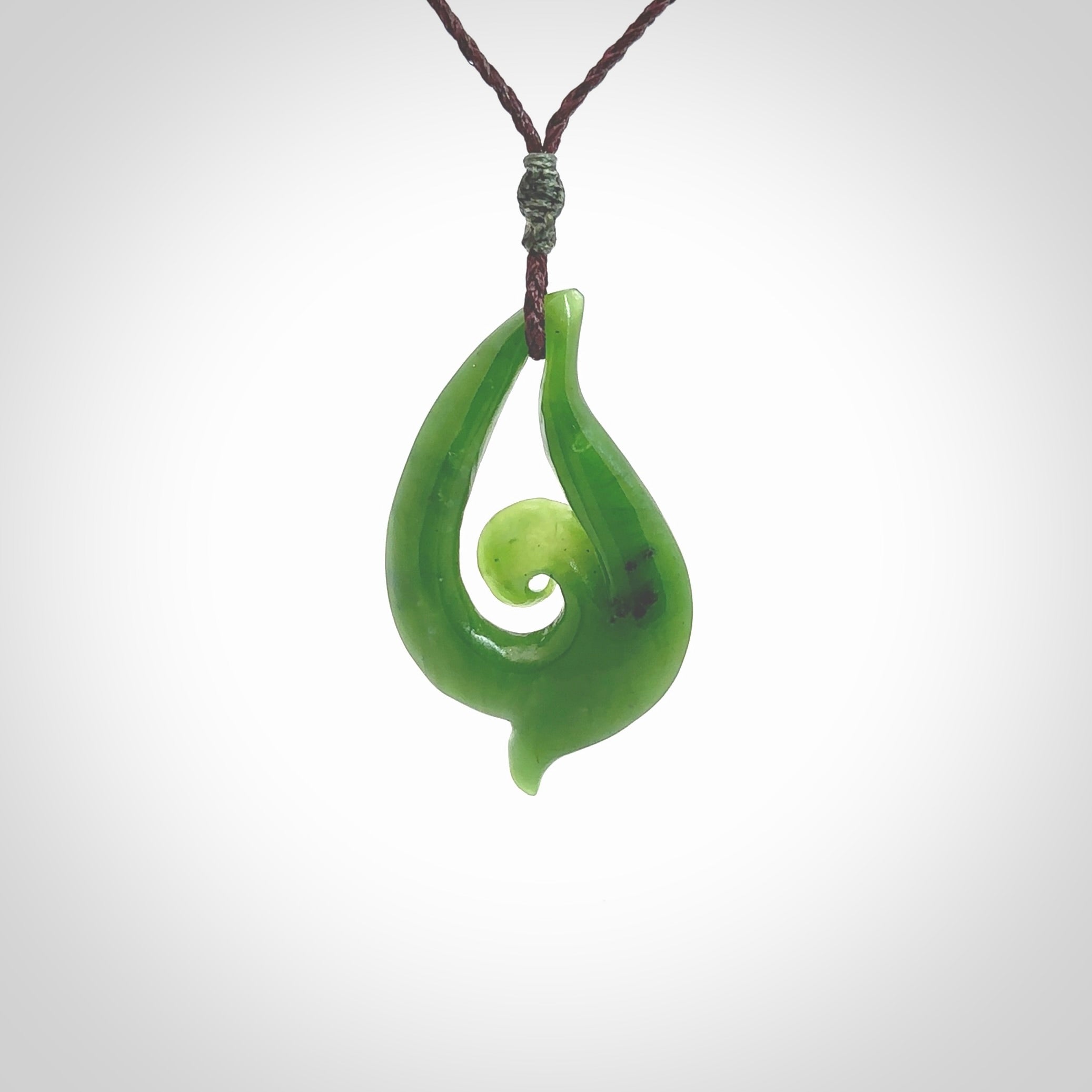 This pendant is a contemporary, medium sized and beautiful koru necklace carved from New Zealand Kawakawa Jade. Ross Crump carved this piece for us so the workmanship is outstanding. Handmade in New Zealand, a beautiful piece of jade jewellery.