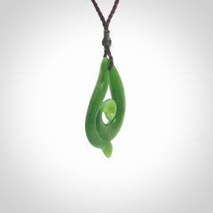 This pendant is a contemporary, medium sized and beautiful koru necklace carved from New Zealand Kawakawa Jade. Ross Crump carved this piece for us so the workmanship is outstanding. Handmade in New Zealand, a beautiful piece of jade jewellery.