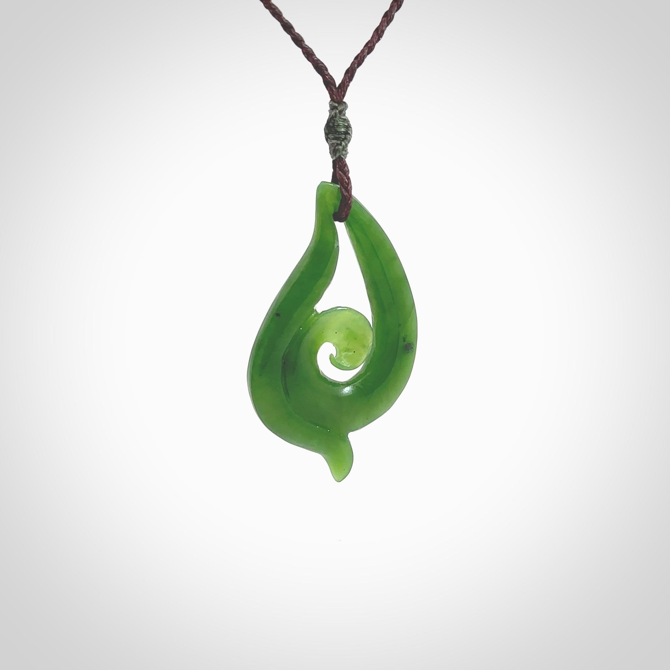 This pendant is a contemporary, medium sized and beautiful koru necklace carved from New Zealand Kawakawa Jade. Ross Crump carved this piece for us so the workmanship is outstanding. Handmade in New Zealand, a beautiful piece of jade jewellery.