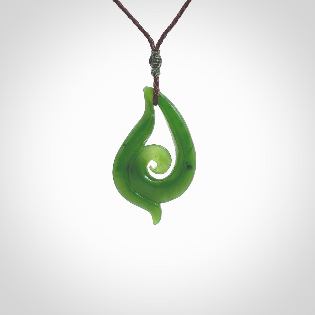 This pendant is a contemporary, medium sized and beautiful koru necklace carved from New Zealand Kawakawa Jade. Ross Crump carved this piece for us so the workmanship is outstanding. Handmade in New Zealand, a beautiful piece of jade jewellery.