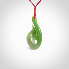 This pendant is a contemporary, large sized and beautiful koru necklace carved from New Zealand Kawakawa Jade. Ross Crump carved this piece for us so the workmanship is outstanding. Handmade in New Zealand, a beautiful piece of jade jewellery.