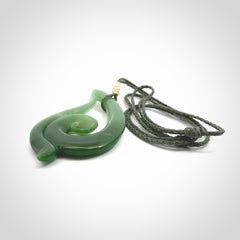 This pendant is a contemporary, large sized and beautiful koru drop necklace carved from New Zealand Inanga Jade. Ross Crump carved this piece for us so the workmanship is outstanding. Handmade in New Zealand, a beautiful piece of jade jewellery.