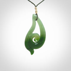 This pendant is a contemporary, large sized and beautiful koru drop necklace carved from New Zealand Inanga Jade. Ross Crump carved this piece for us so the workmanship is outstanding. Handmade in New Zealand, a beautiful piece of jade jewellery.