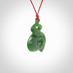 A beautiful carved double twist with koru pendant. This piece has been carved for us by Ross Crump and is a truly beautiful carving made from some of our finest and rarest jade. We will ship this to you with an express courier so you will have it quickly. A rare and beautiful work of wearable art from NZ Pacific.