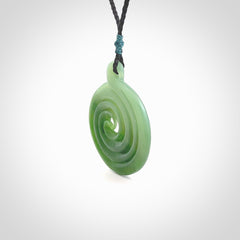 This pendant is a large sized and beautiful koru necklace carved from an semi-translucent light and dark green piece of New Zealand Kawakawa Jade. Ross Crump carved this piece for us so the workmanship is outstanding. Handmade in New Zealand, a beautiful piece of jade jewellery.