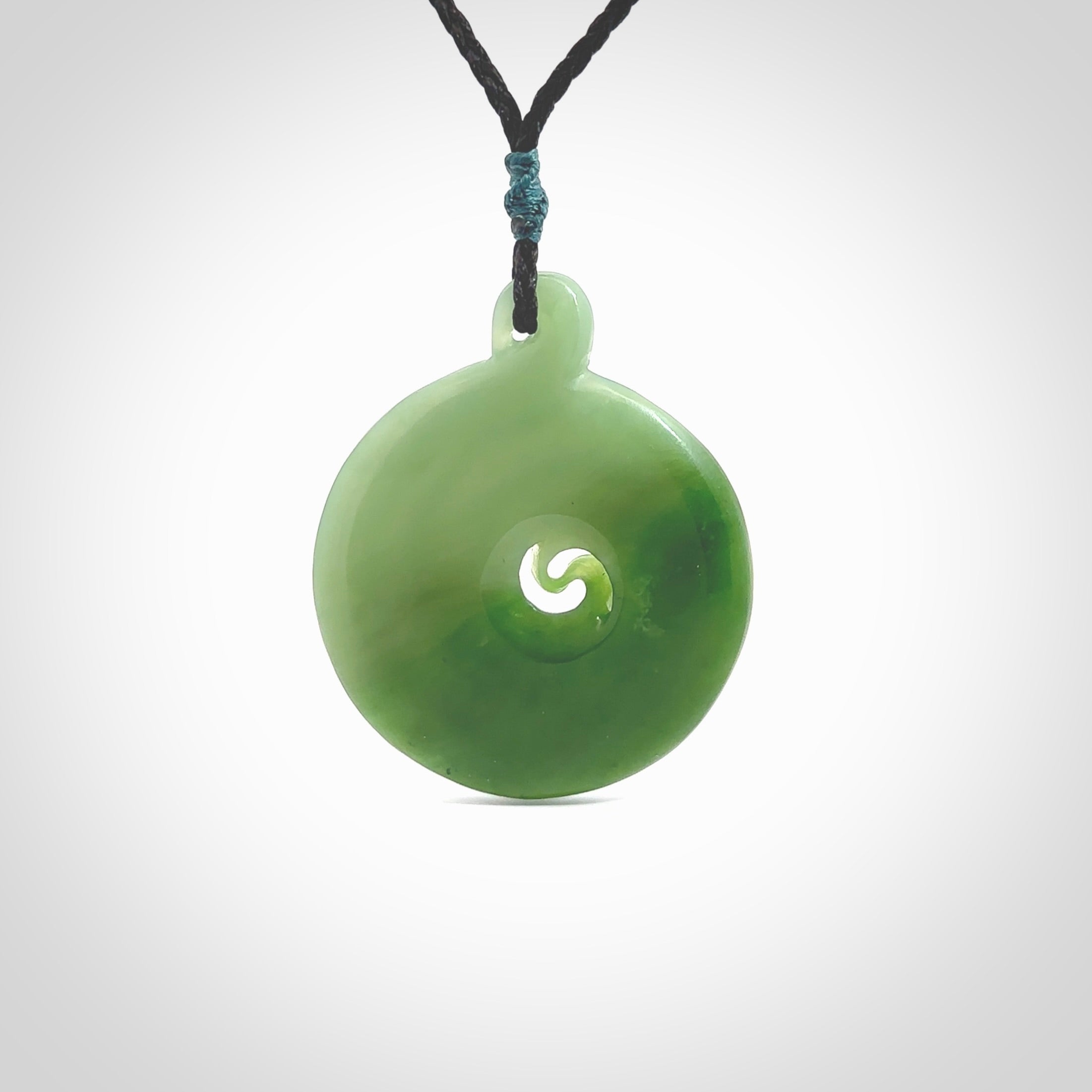 This pendant is a large sized and beautiful koru necklace carved from an semi-translucent light and dark green piece of New Zealand Kawakawa Jade. Ross Crump carved this piece for us so the workmanship is outstanding. Handmade in New Zealand, a beautiful piece of jade jewellery.