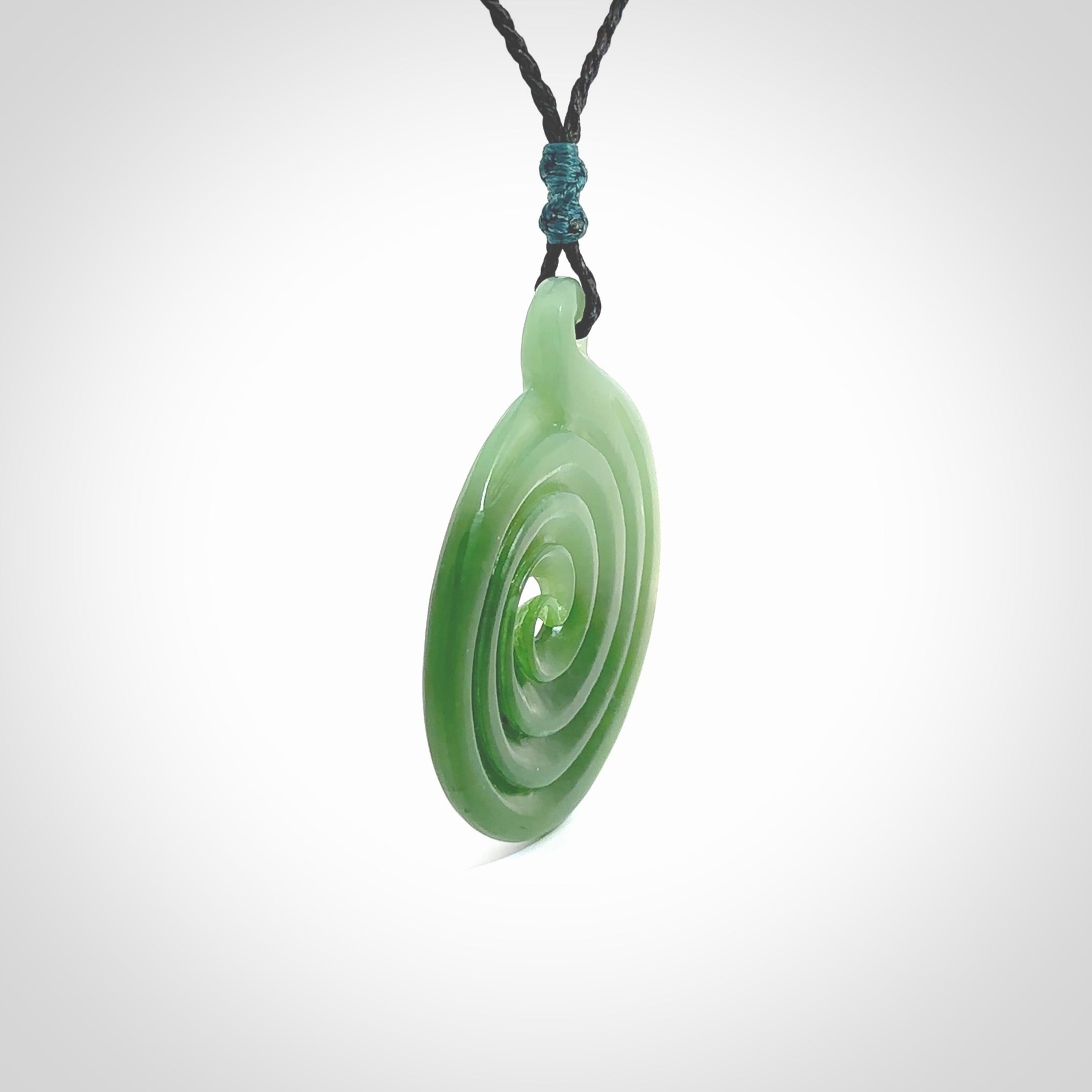 This pendant is a large sized and beautiful koru necklace carved from an semi-translucent light and dark green piece of New Zealand Kawakawa Jade. Ross Crump carved this piece for us so the workmanship is outstanding. Handmade in New Zealand, a beautiful piece of jade jewellery.