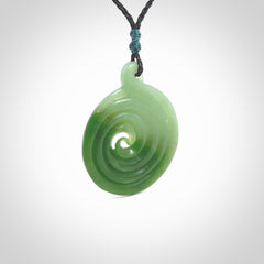 This pendant is a large sized and beautiful koru necklace carved from an semi-translucent light and dark green piece of New Zealand Kawakawa Jade. Ross Crump carved this piece for us so the workmanship is outstanding. Handmade in New Zealand, a beautiful piece of jade jewellery.