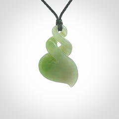 This piece is a fine, delicate drop shaped, double twist pendant. It was carved for us by Ross Crump from a lovely bright semi-translucent green piece of New Zealand Inanga jade. It is suspended on an manuka green coloured braided cord that is length adjustable.