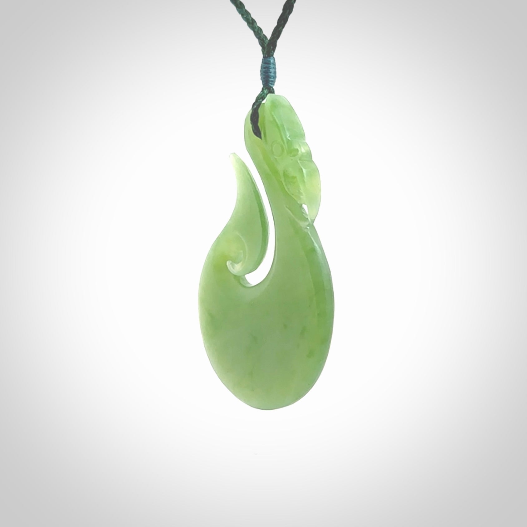 A New Zealand jade manaia necklace carved in lovely New Zealand Inanga jade. The pendant is suspended from a plaited cord. The cord is length adjustable so you can position the pendant where it suits you best. One only Ross Crump Manaia with hook pendant.