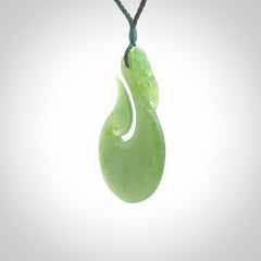 A New Zealand jade manaia necklace carved in lovely New Zealand Inanga jade. The pendant is suspended from a plaited cord. The cord is length adjustable so you can position the pendant where it suits you best. One only Ross Crump Manaia with hook pendant.