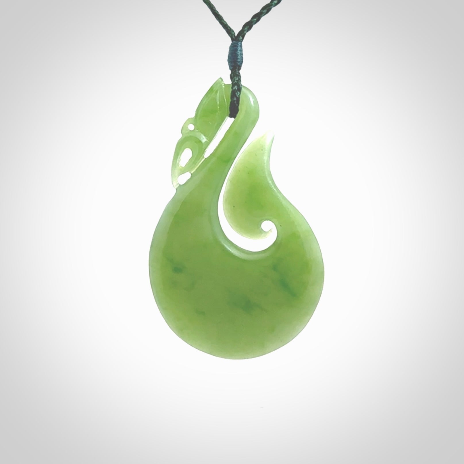 A New Zealand jade manaia necklace carved in lovely New Zealand Inanga jade. The pendant is suspended from a plaited cord. The cord is length adjustable so you can position the pendant where it suits you best. One only Ross Crump Manaia with hook pendant.