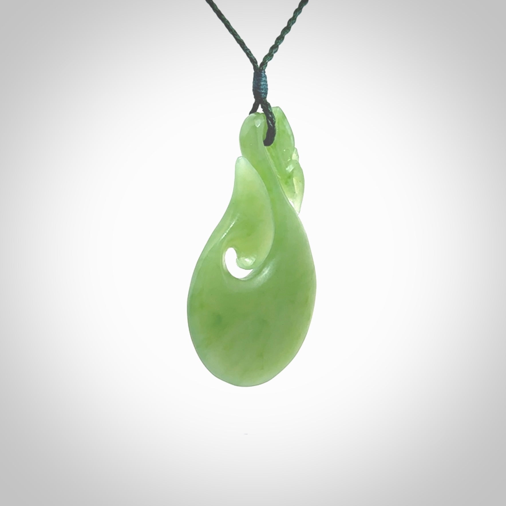 A New Zealand jade manaia necklace carved in lovely New Zealand Inanga jade. The pendant is suspended from a plaited cord. The cord is length adjustable so you can position the pendant where it suits you best. One only Ross Crump Manaia with hook pendant.