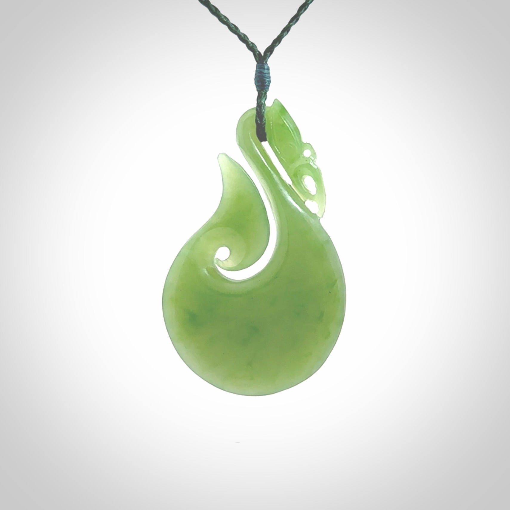 A New Zealand jade manaia necklace carved in lovely New Zealand Inanga jade. The pendant is suspended from a plaited cord. The cord is length adjustable so you can position the pendant where it suits you best. One only Ross Crump Manaia with hook pendant.