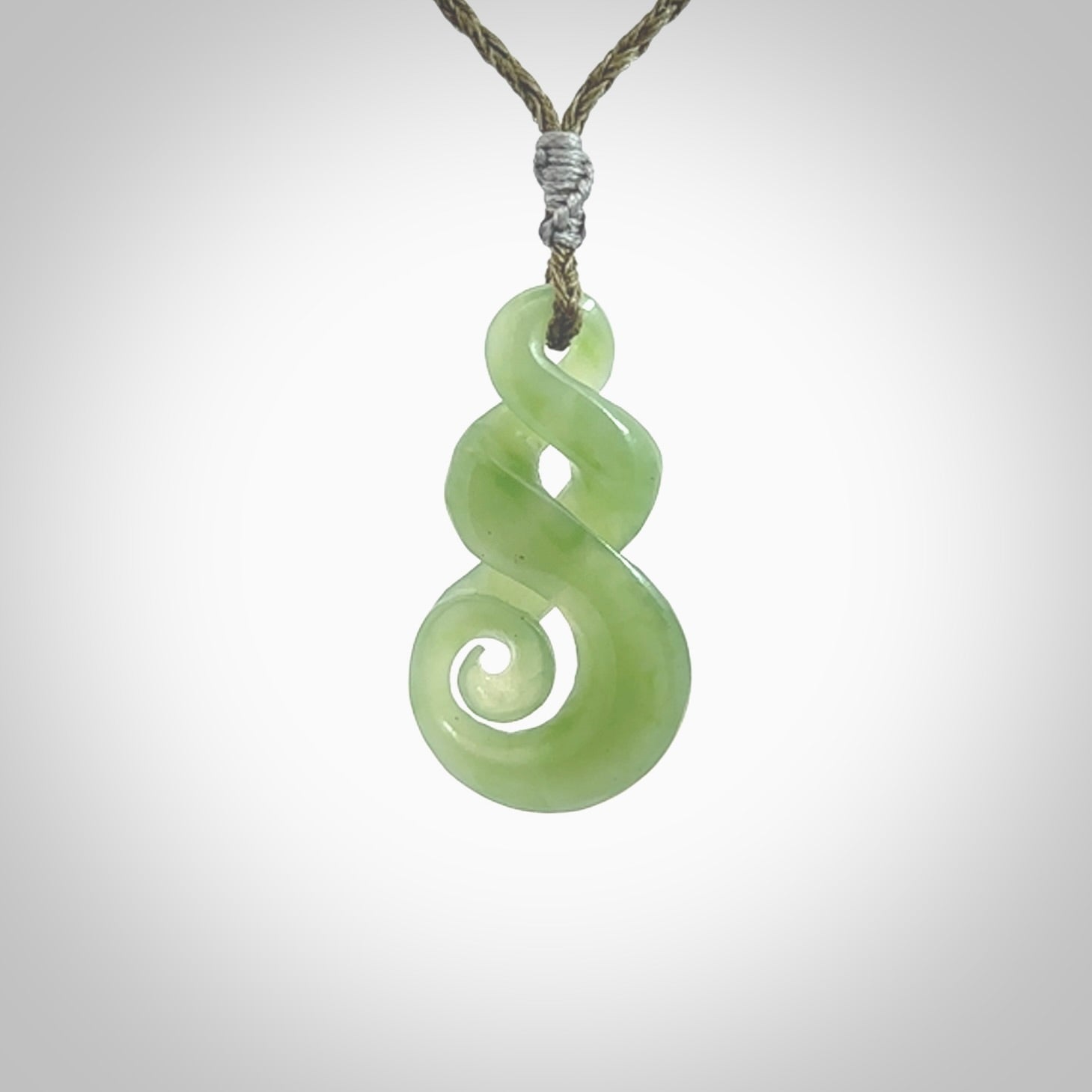 A beautiful carved, complex double twist pendant. This piece has been carved for us by Ross Crump and is a truly beautiful carving made from some of our finest and rarest Inanga jade. We will ship this to you with an express courier so you will have it quickly. A rare and beautiful work of wearable art from NZ Pacific.