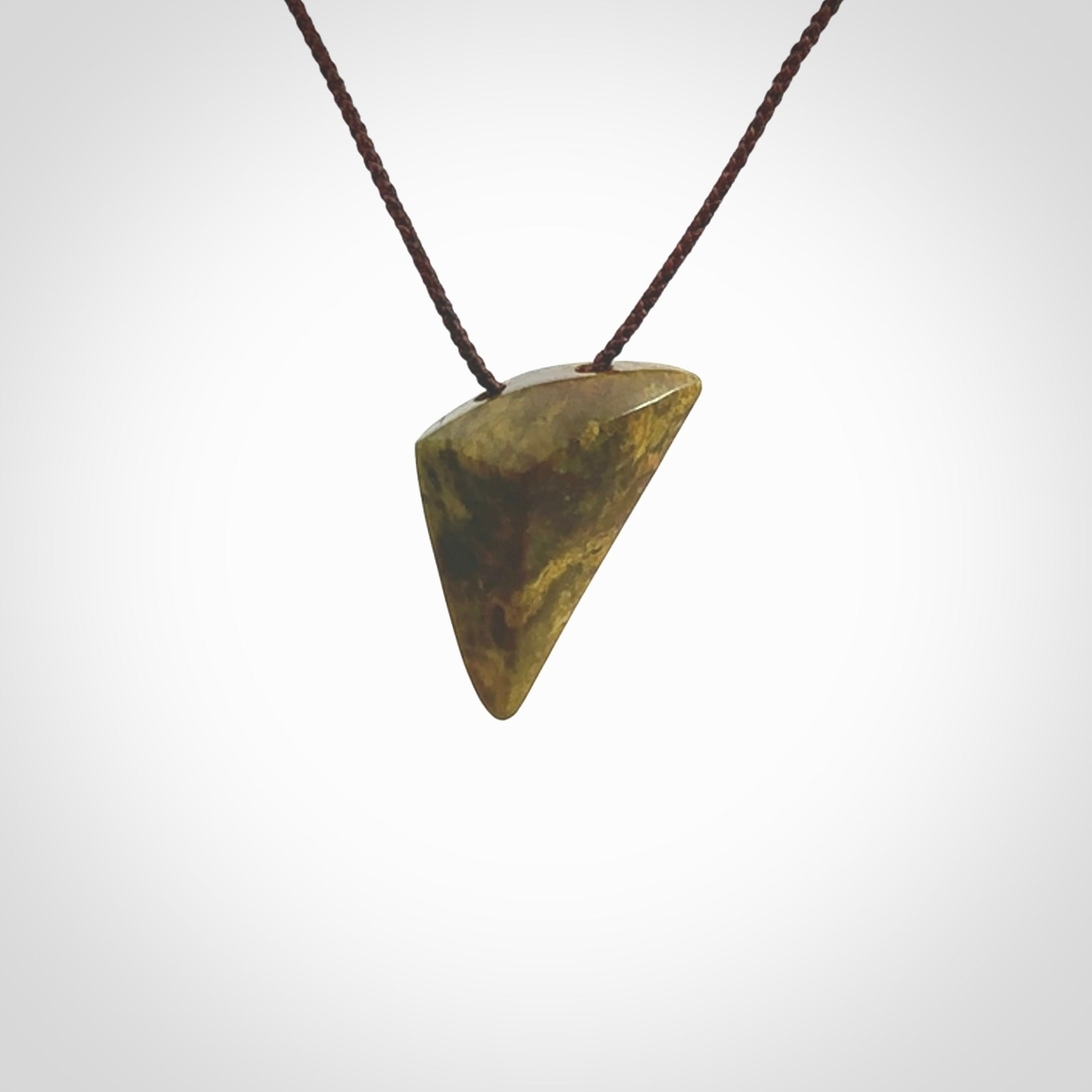 Hand carved pounamu drop pendant. Jade necklace hand made in New Zealand. A contemporary drop pendant carved from rare New Zealand flower jade. NZ Pacific jade jewellery for sale online. Provided with adjustable brown cord.