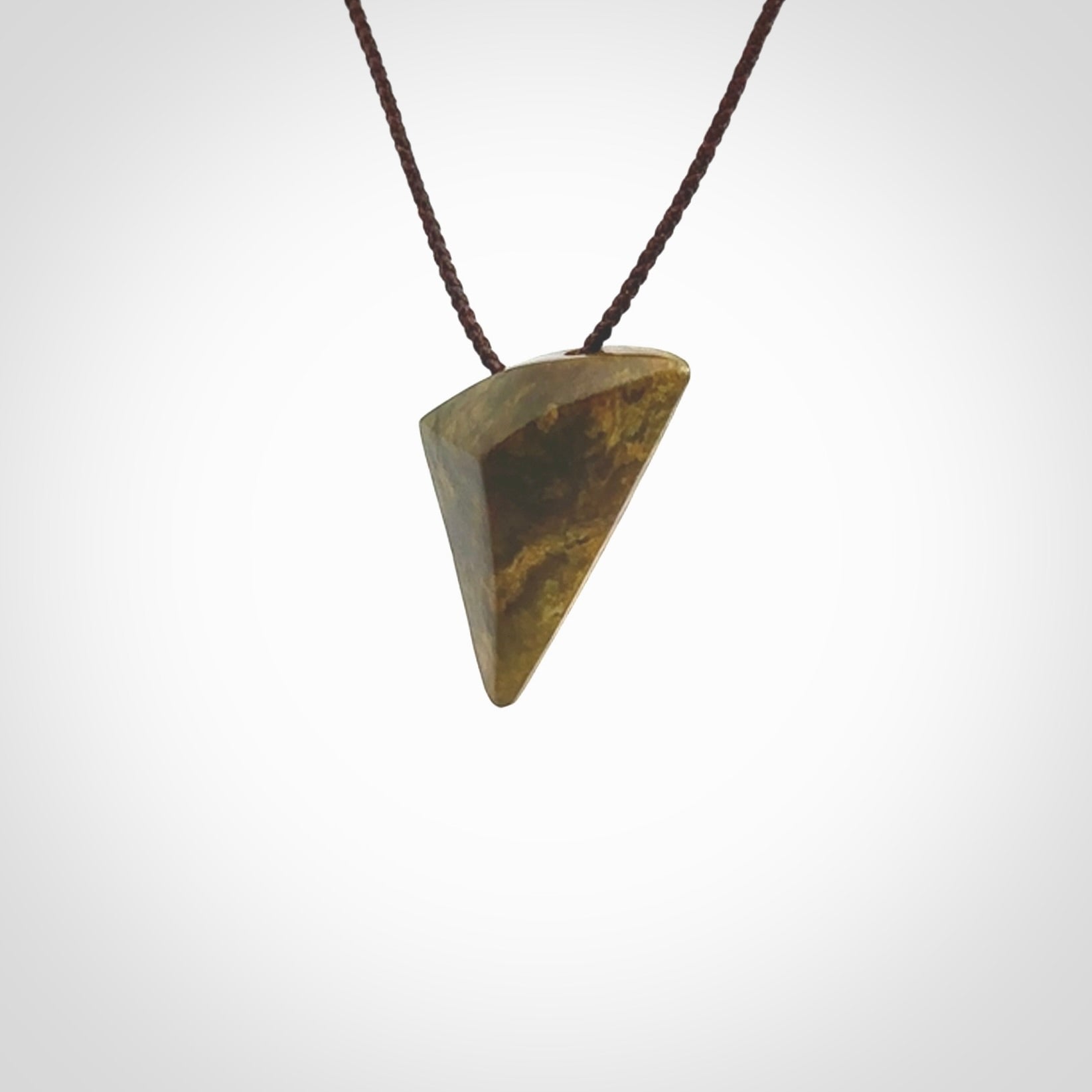 Hand carved pounamu drop pendant. Jade necklace hand made in New Zealand. A contemporary drop pendant carved from rare New Zealand flower jade. NZ Pacific jade jewellery for sale online. Provided with adjustable brown cord.