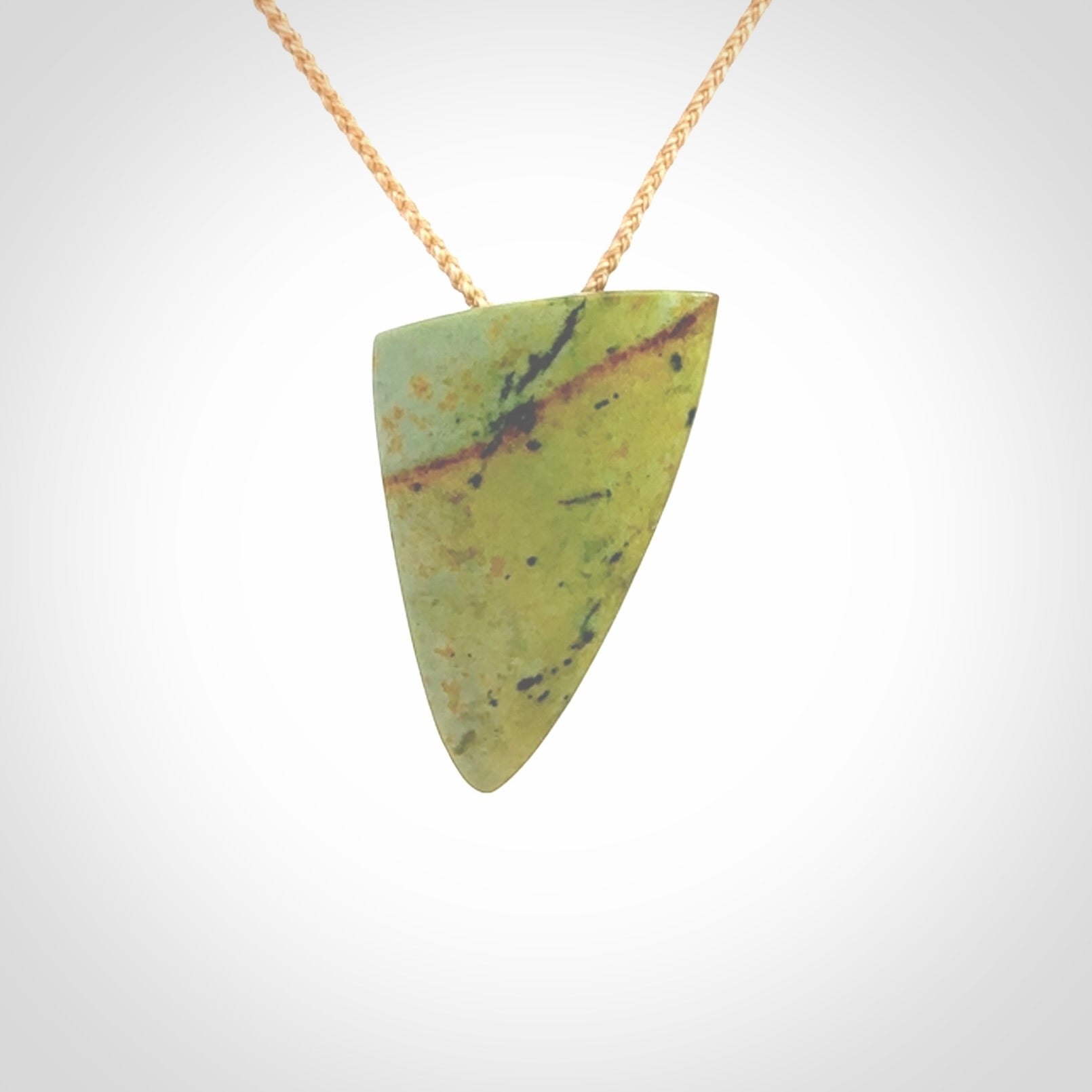 Hand carved pounamu drop pendant. Jade necklace hand made in New Zealand. A contemporary drop pendant carved from rare New Zealand flower jade. NZ Pacific jade jewellery for sale online.