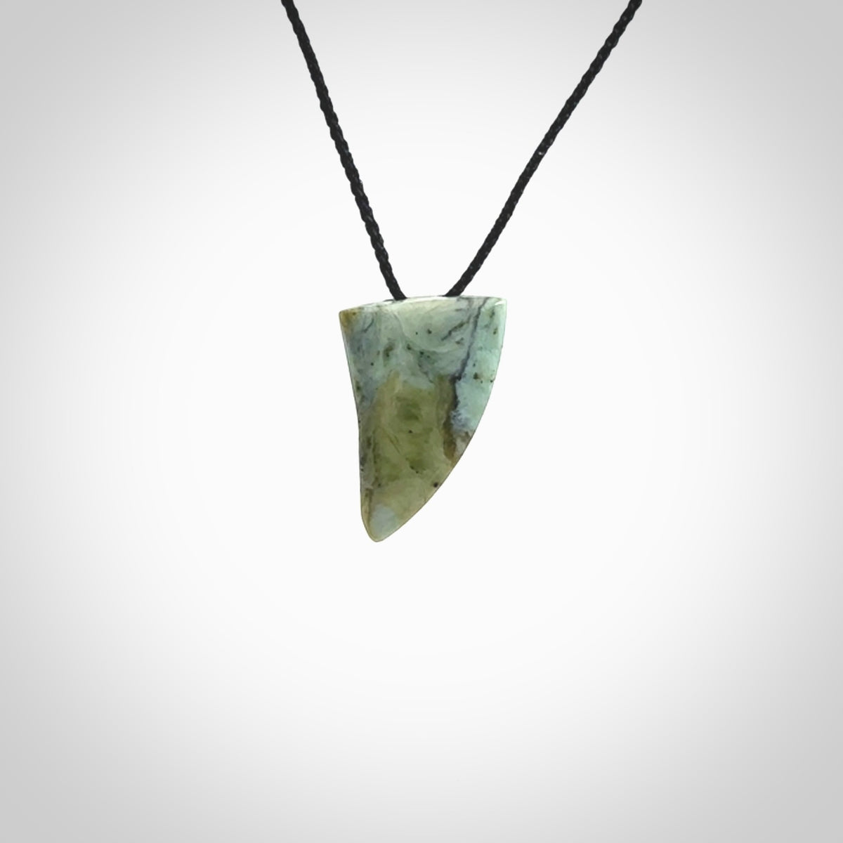 This is a lovely New Zealand Jade, pounamu drop pendant. Hand carved for us by Ric Moor. It is bound with an adjustable black coloured cord which is length adjustable. Free worldwide shipping.