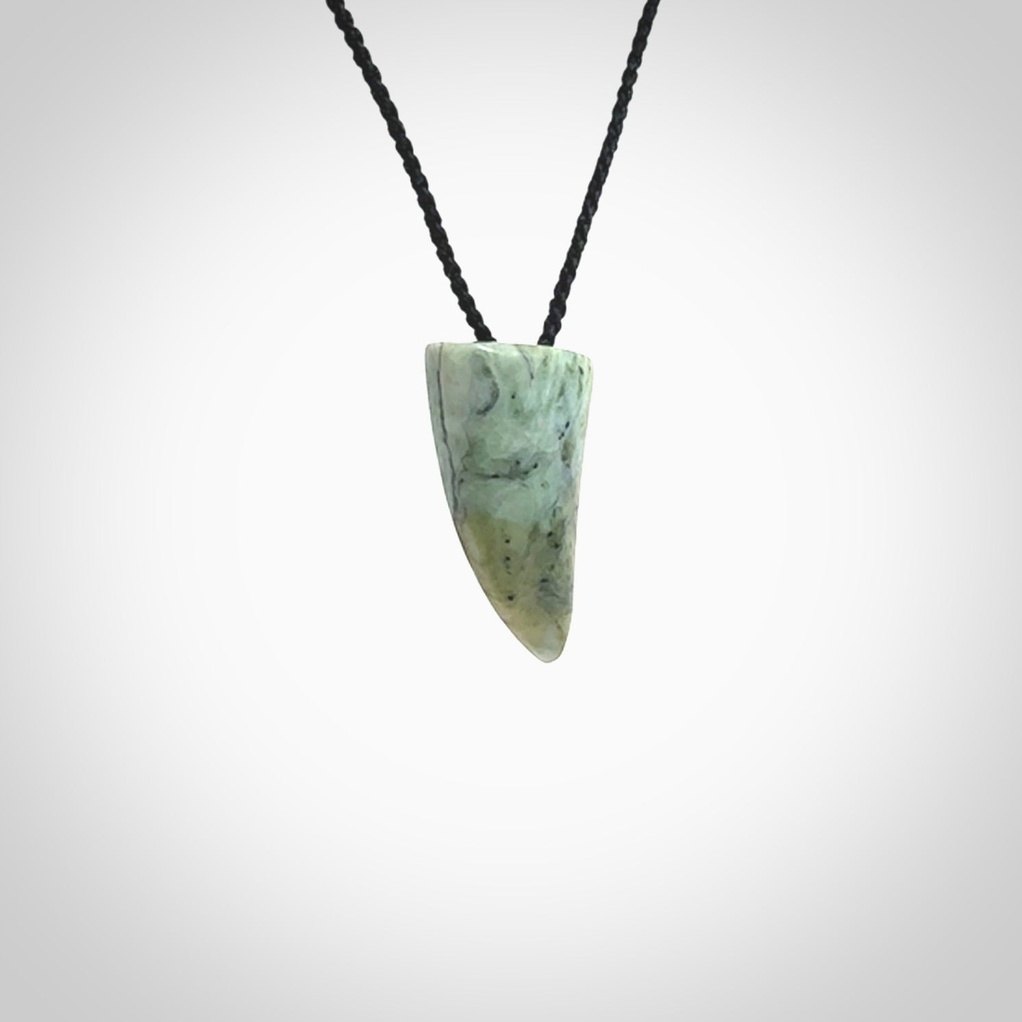 This is a lovely New Zealand Jade, pounamu drop pendant. Hand carved for us by Ric Moor. It is bound with an adjustable black coloured cord which is length adjustable. Free worldwide shipping.