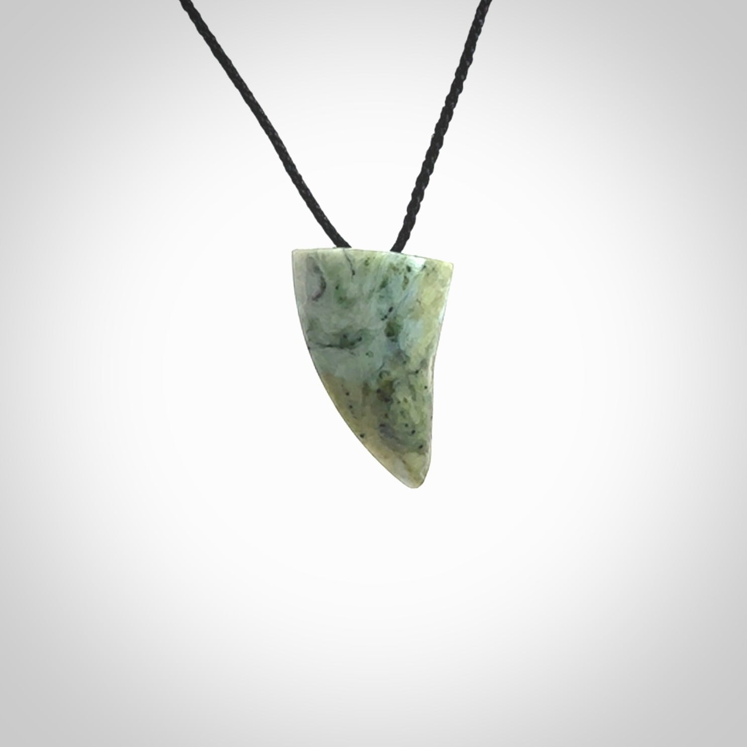 This is a lovely New Zealand Jade, pounamu drop pendant. Hand carved for us by Ric Moor. It is bound with an adjustable black coloured cord which is length adjustable. Free worldwide shipping.