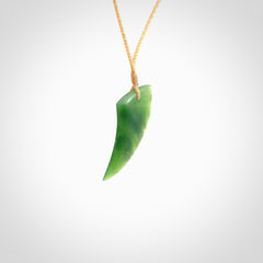 Hand carved medium sized pounamu drop pendant by Ric Moor. Jade drop necklace hand made in New Zealand. A contemporary drop pendant carved from rare New Zealand jade. NZ Pacific jade jewellery for sale online. One only, packaged in a woven kete pouch. Provided with a beige adjustable cord.