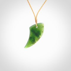 Hand carved medium sized pounamu drop pendant by Ric Moor. Jade drop necklace hand made in New Zealand. A contemporary drop pendant carved from rare New Zealand jade. NZ Pacific jade jewellery for sale online. One only, packaged in a woven kete pouch. Provided with a beige adjustable cord.