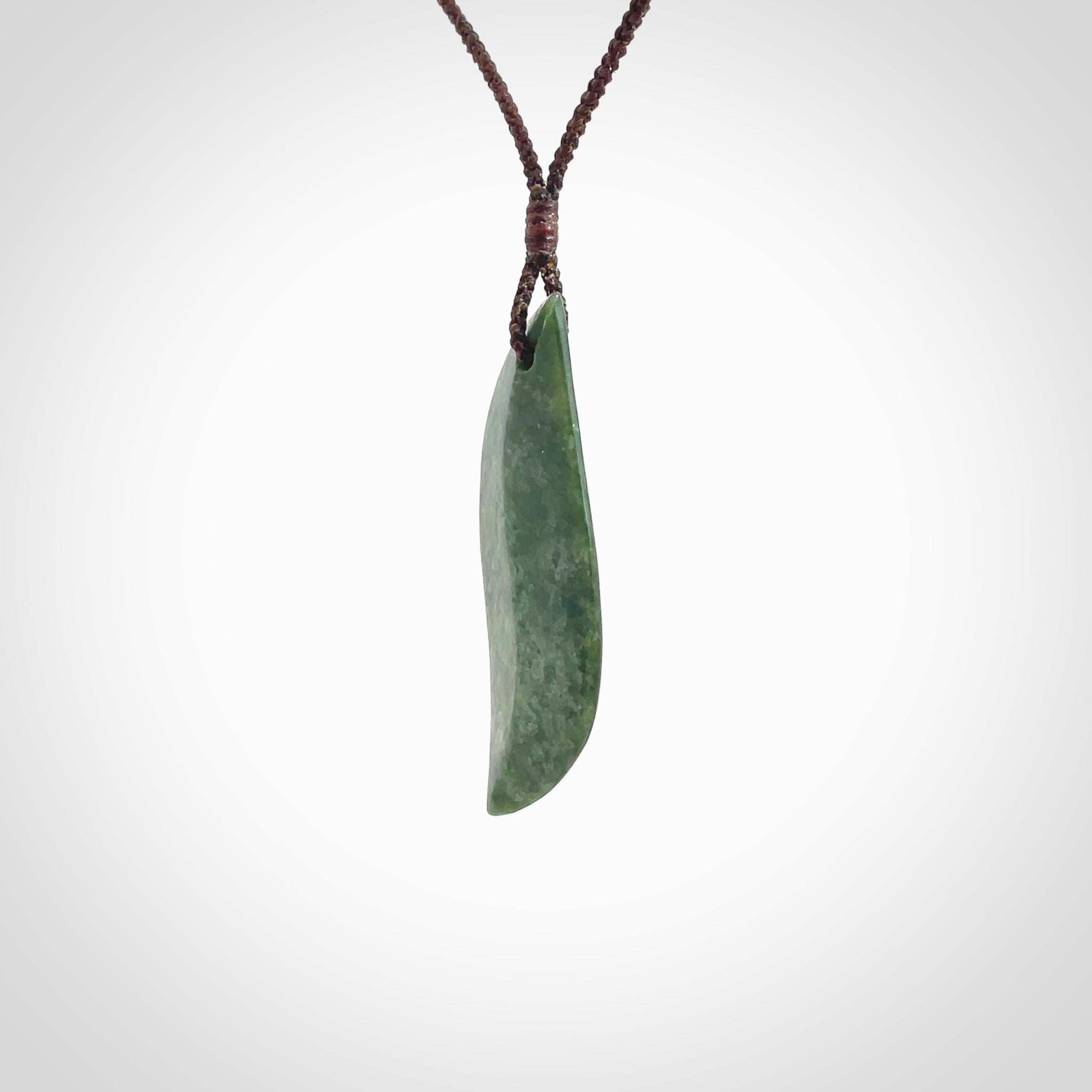 This is a lovely New Zealand Jade, pounamu drop pendant. Hand carved for us by Ric Moor. It is bound with an adjustable brown coloured cord which is length adjustable. Free worldwide shipping.