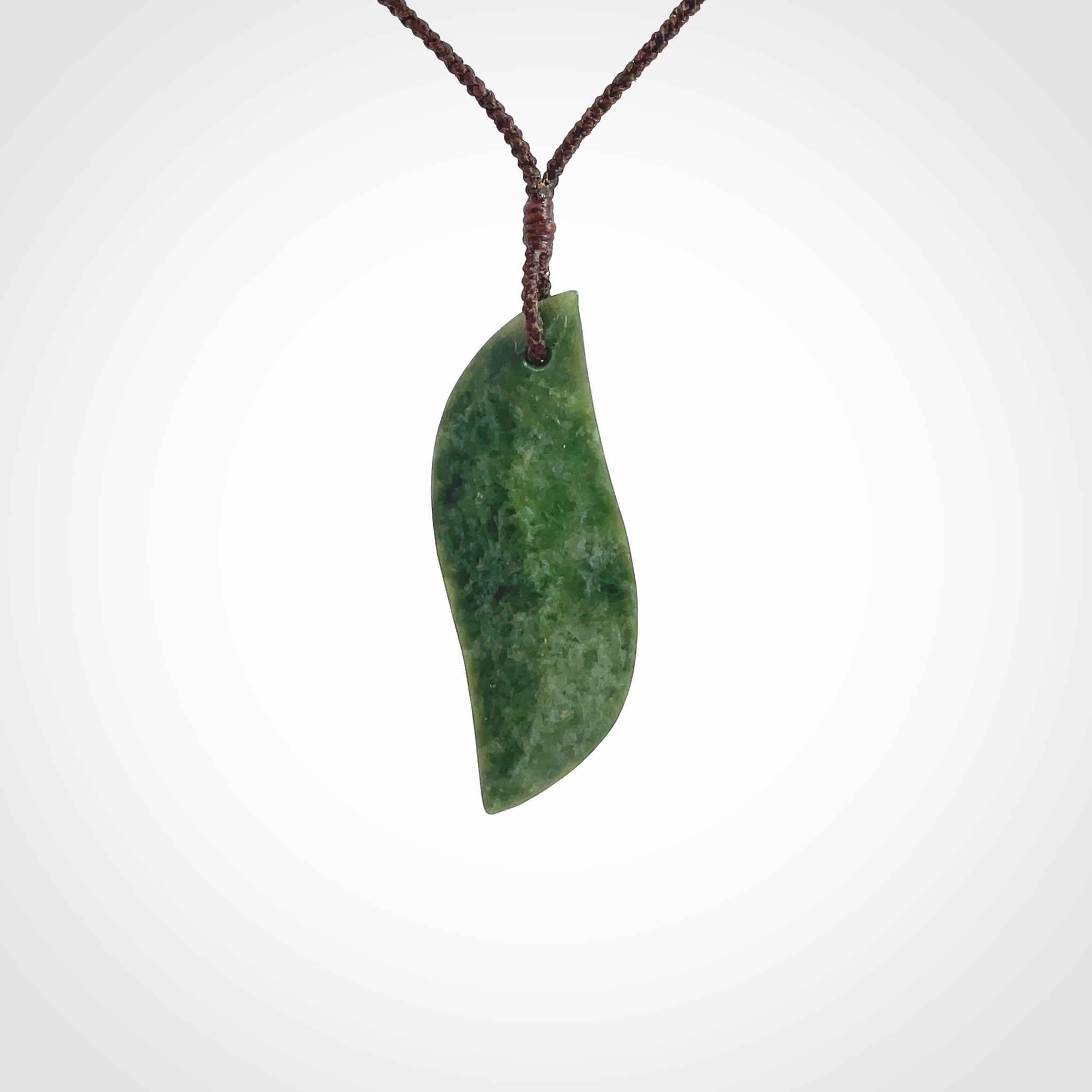 This is a lovely New Zealand Jade, pounamu drop pendant. Hand carved for us by Ric Moor. It is bound with an adjustable brown coloured cord which is length adjustable. Free worldwide shipping.