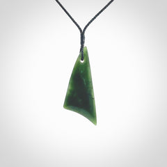 Hand carved pounamu drop pendant. Jade necklace hand made in New Zealand. A contemporary drop pendant carved from rare New Zealand jade. NZ Pacific jade jewellery for sale online. Provided with an adjustable black cord and packaged in a woven kete pouch.