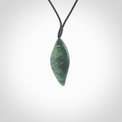 This photo shows a small jade drop shaped pendant. It a a lovely deep green jade. The cord is a four plait black and is adjustable in length. One only small, contemporary drop necklace from Jade, by Ric Moor.