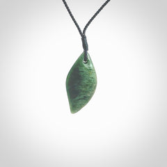 This photo shows a small jade drop shaped pendant. It a a lovely deep green jade. The cord is a four plait black and is adjustable in length. One only small, contemporary drop necklace from Jade, by Ric Moor.