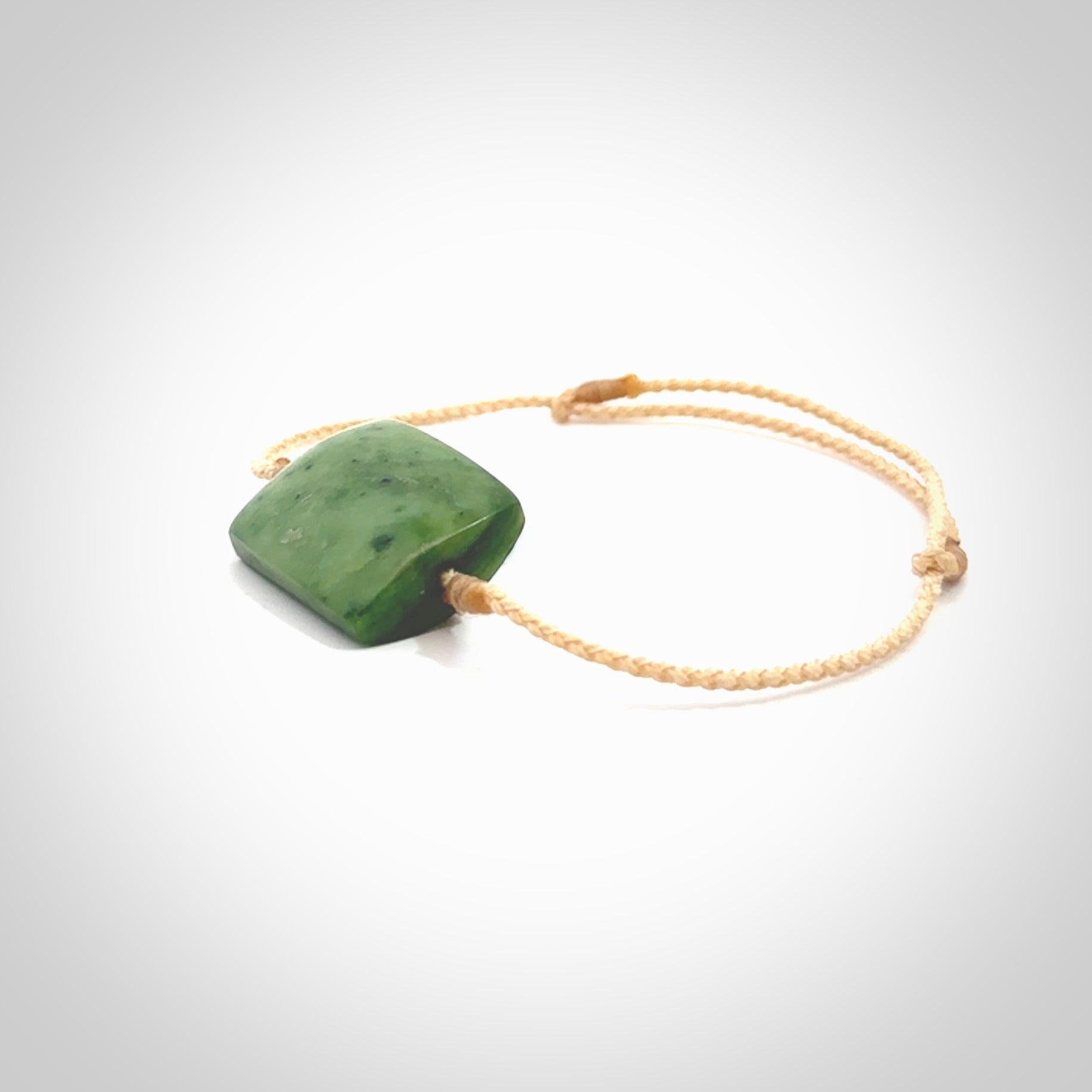 Hand carved New Zealand Jade adjustable armband. Hand made by Ric Moor, this beautiful jade bracelet has a beige adjustable cord. One only.