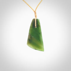 A lovely New Zealand jade drop pendant. This piece is made from a semi-translucent jade and is a wonderful deep green colour. Carved by Ric Moor for NZ Pacific and delivered worldwide. Provided with an adjustable beige cord.