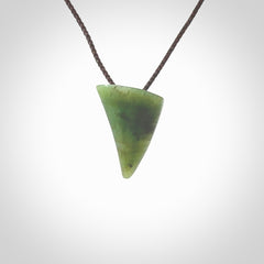 This is a lovely New Zealand Jade, pounamu drop pendant. Hand carved for us by Ric Moor. It is bound with an adjustable brown coloured cord which is length adjustable. Free worldwide shipping.