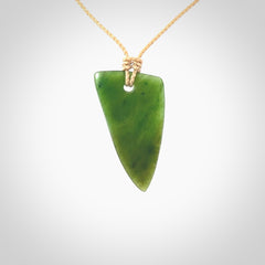 A lovely New Zealand jade drop pendant. This piece is made from a semi-translucent jade and is a wonderful deep green colour. Carved by Ric Moor for NZ Pacific and delivered worldwide. Provided with an adjustable beige cord.