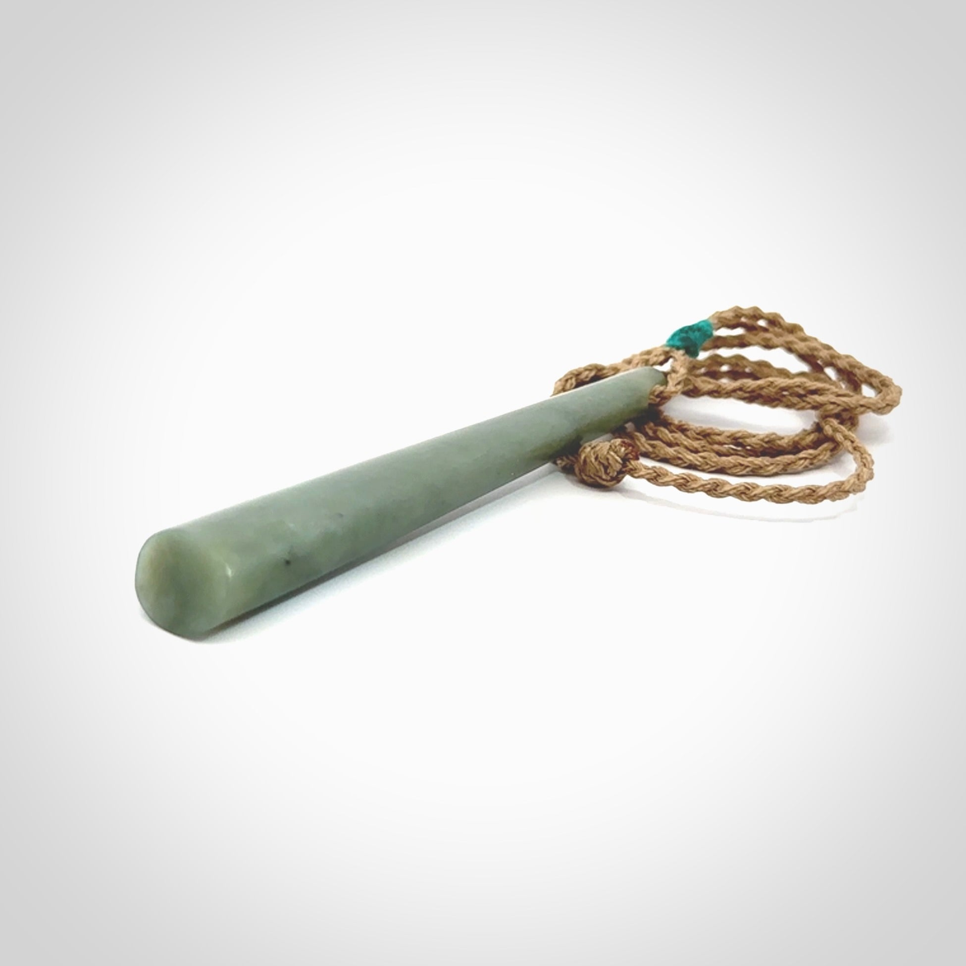 This photo shows a large Inanga jade drop shaped pendant. It is a lovely, stunning Inanga Pounamu. The cord is a four plait kalahari tan and is adjustable in length. One only large, contemporary drop necklace from Jade, by Rueben Tipene.