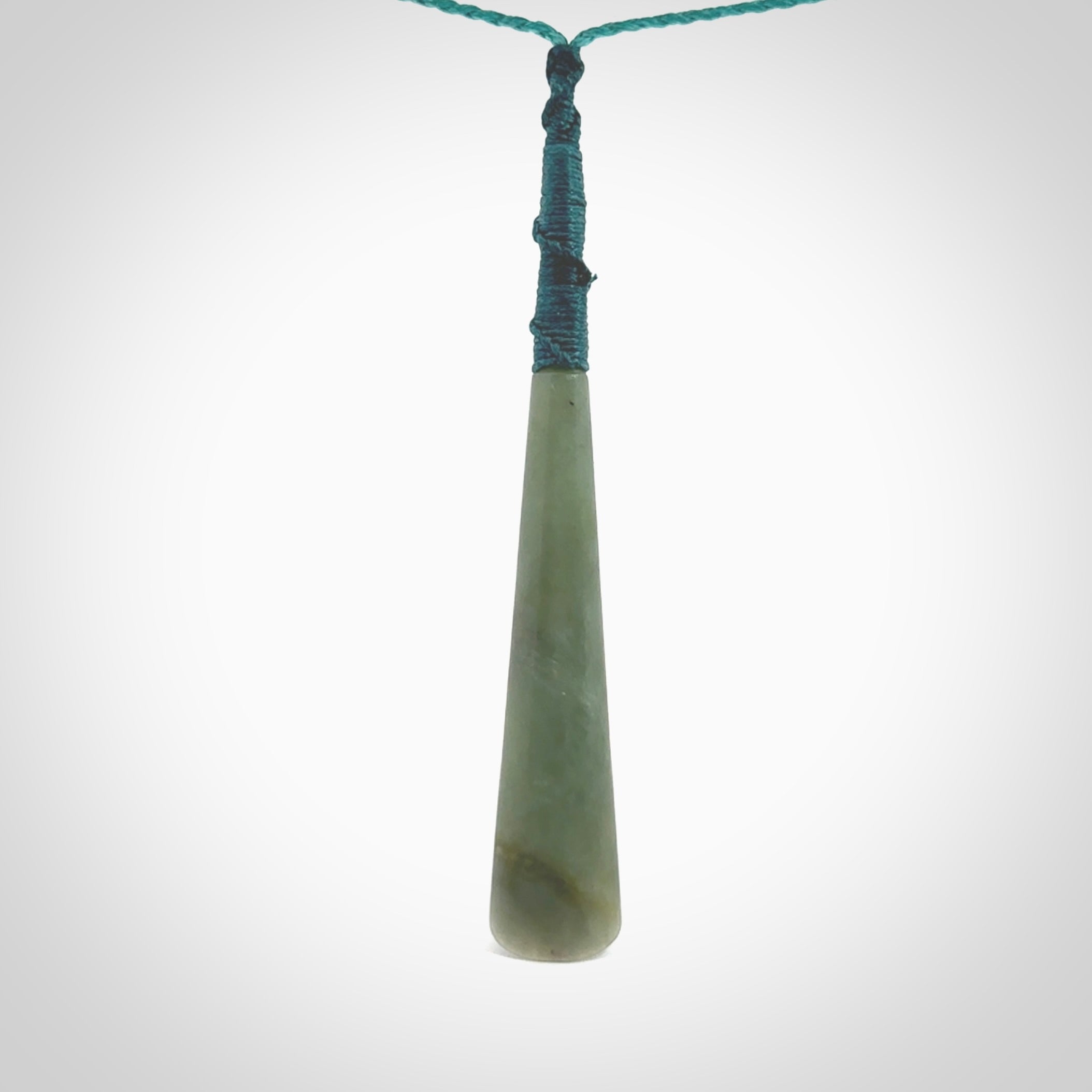 This photo shows a large Inanga jade drop shaped pendant. It is a lovely, stunning Inanga Pounamu. The cord is blue and is adjustable in length. One only large, contemporary drop necklace from Jade, by Rueben Tipene.