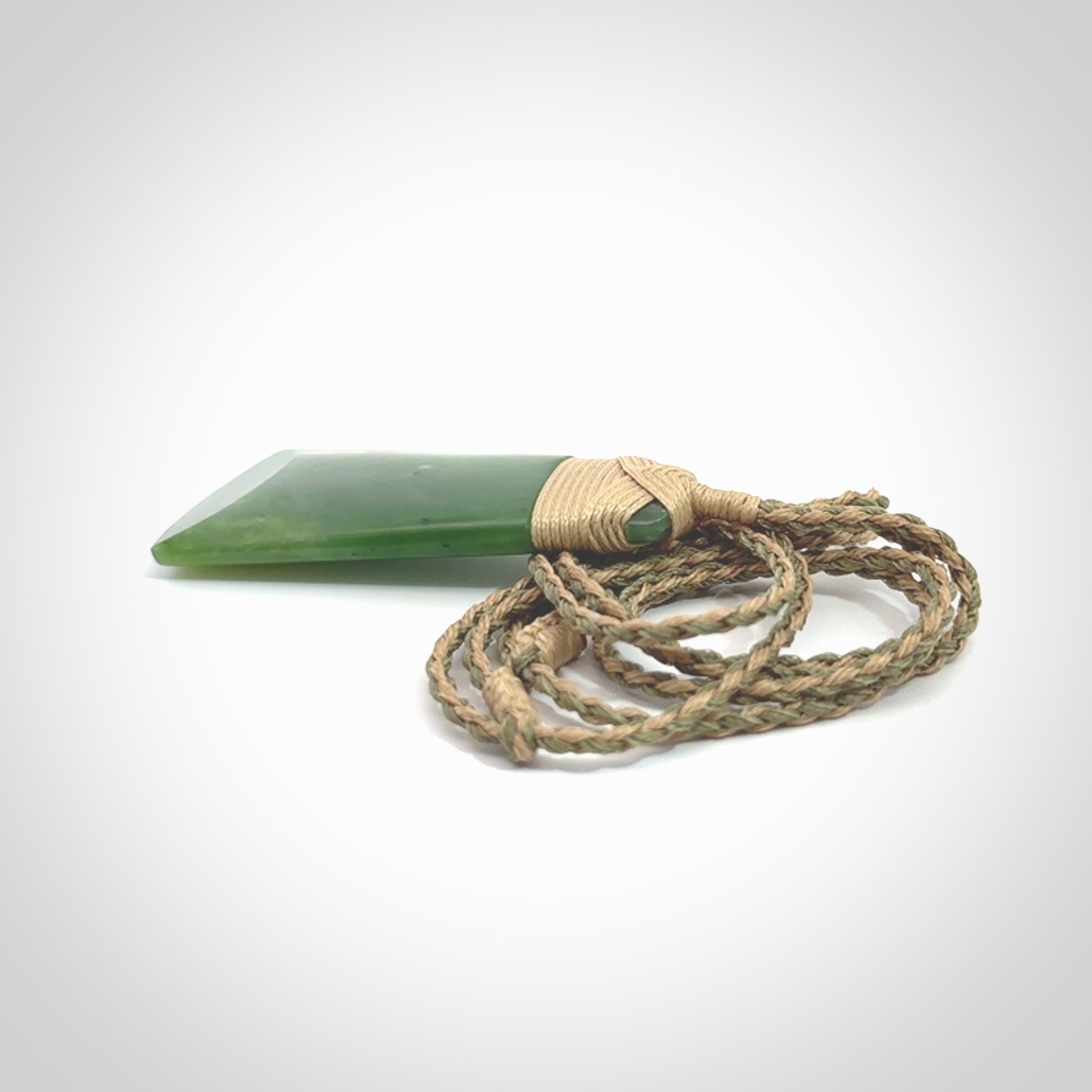 Hand made large New Zealand Kawakawa jade toki pendant. Hand carved in New Zealand by Rueben Tipene. Hand made jewellery. Unique Jade Toki with adjustable cord. Free shipping worldwide.