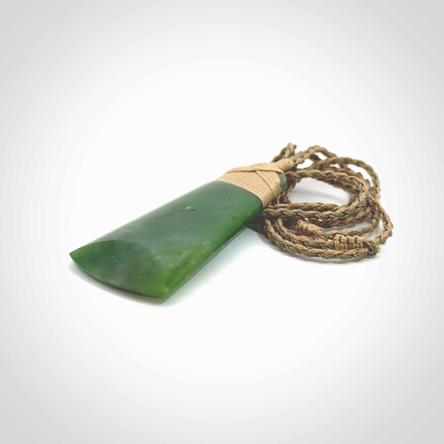 Hand made large New Zealand Kawakawa jade toki pendant. Hand carved in New Zealand by Rueben Tipene. Hand made jewellery. Unique Jade Toki with adjustable cord. Free shipping worldwide.