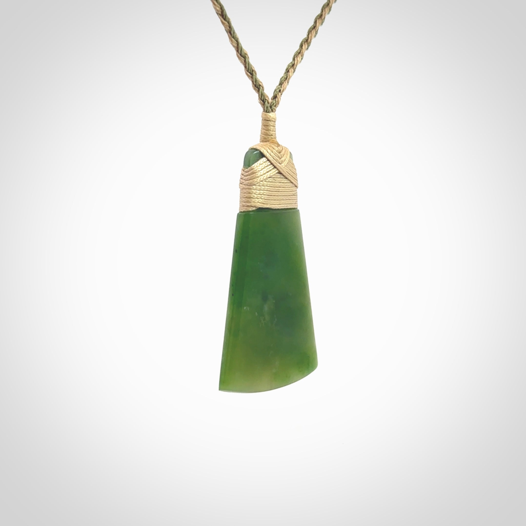 Hand made large New Zealand Kawakawa jade toki pendant. Hand carved in New Zealand by Rueben Tipene. Hand made jewellery. Unique Jade Toki with adjustable cord. Free shipping worldwide.