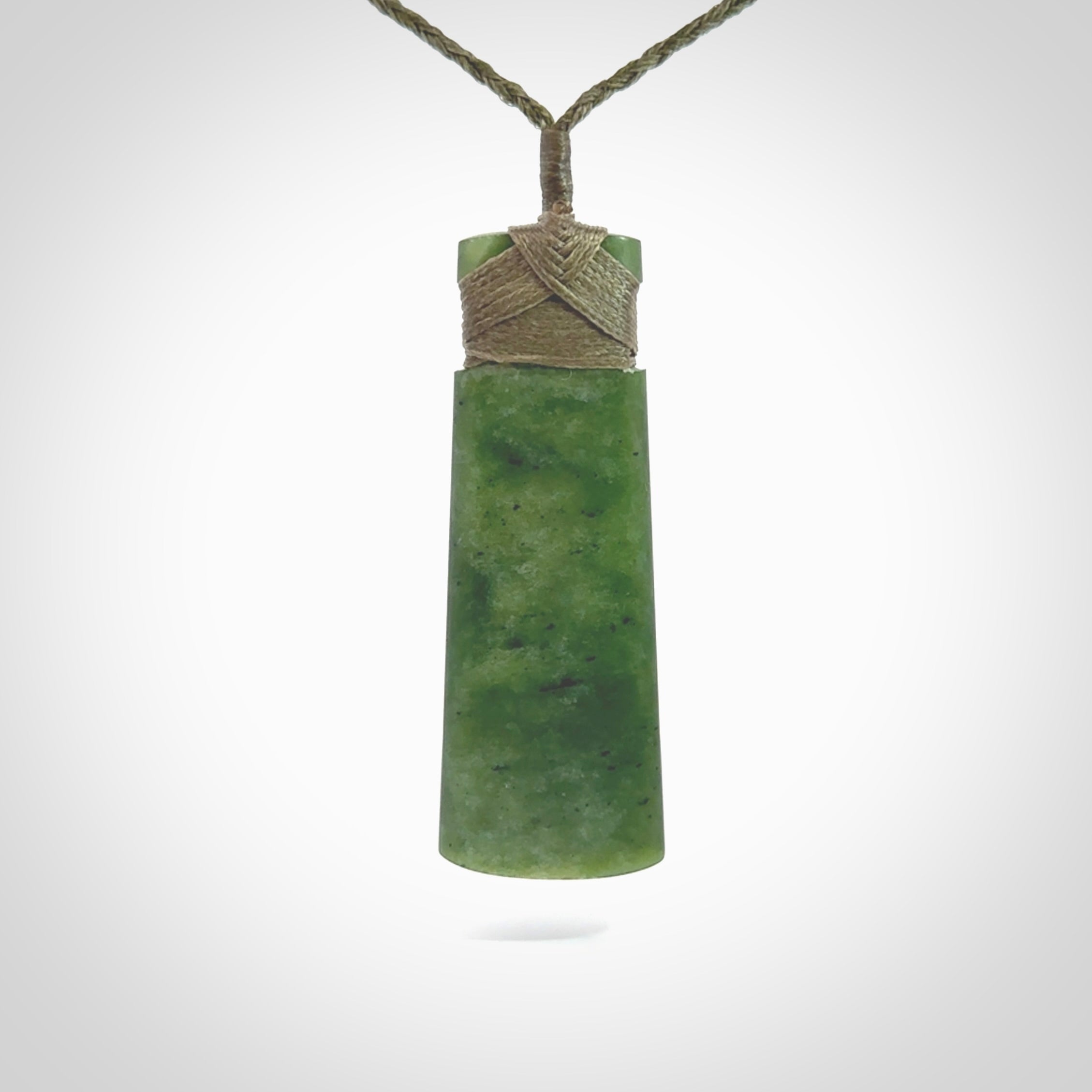 Hand made large New Zealand Kawakawa jade toki pendant. Hand carved in New Zealand by Rueben Tipene. Hand made jewellery. Unique Jade Toki with adjustable cord. Free shipping worldwide.