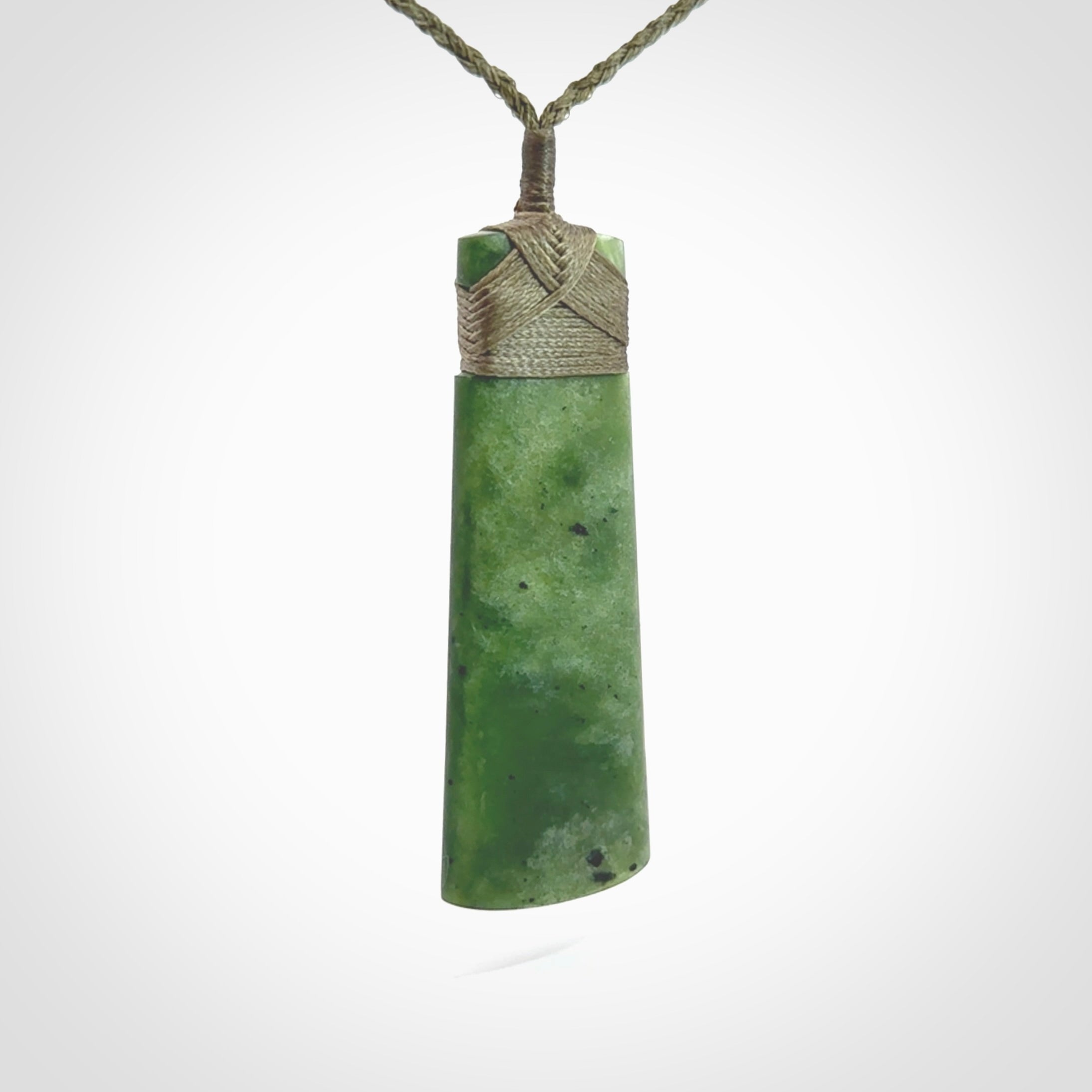 Hand made large New Zealand Kawakawa jade toki pendant. Hand carved in New Zealand by Rueben Tipene. Hand made jewellery. Unique Jade Toki with adjustable cord. Free shipping worldwide.