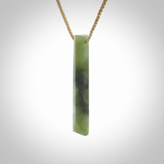 This photo shows a large Totoweka jade drop shaped pendant. It a a lovely, semi-translucent jade. The cord is tan and is adjustable in length. One only large, contemporary drop necklace from New Zealand Totoweka Jade, by Rueben Tipene.