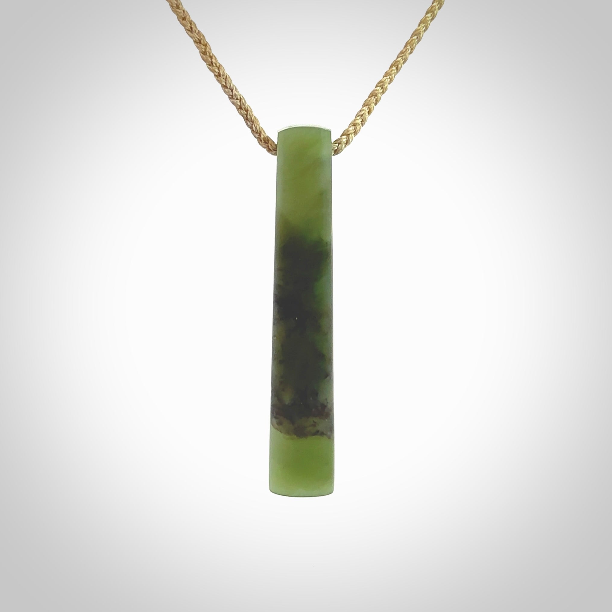 This photo shows a large Totoweka jade drop shaped pendant. It a a lovely, semi-translucent jade. The cord is tan and is adjustable in length. One only large, contemporary drop necklace from New Zealand Totoweka Jade, by Rueben Tipene.