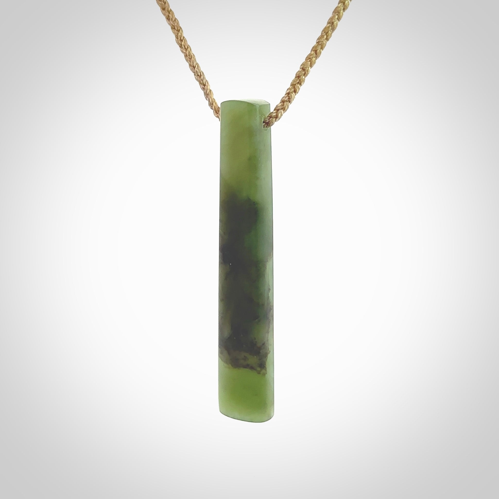 This photo shows a large Totoweka jade drop shaped pendant. It a a lovely, semi-translucent jade. The cord is tan and is adjustable in length. One only large, contemporary drop necklace from New Zealand Totoweka Jade, by Rueben Tipene.